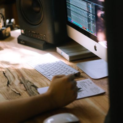 Student working on Logic Pro at their sunlit desk.